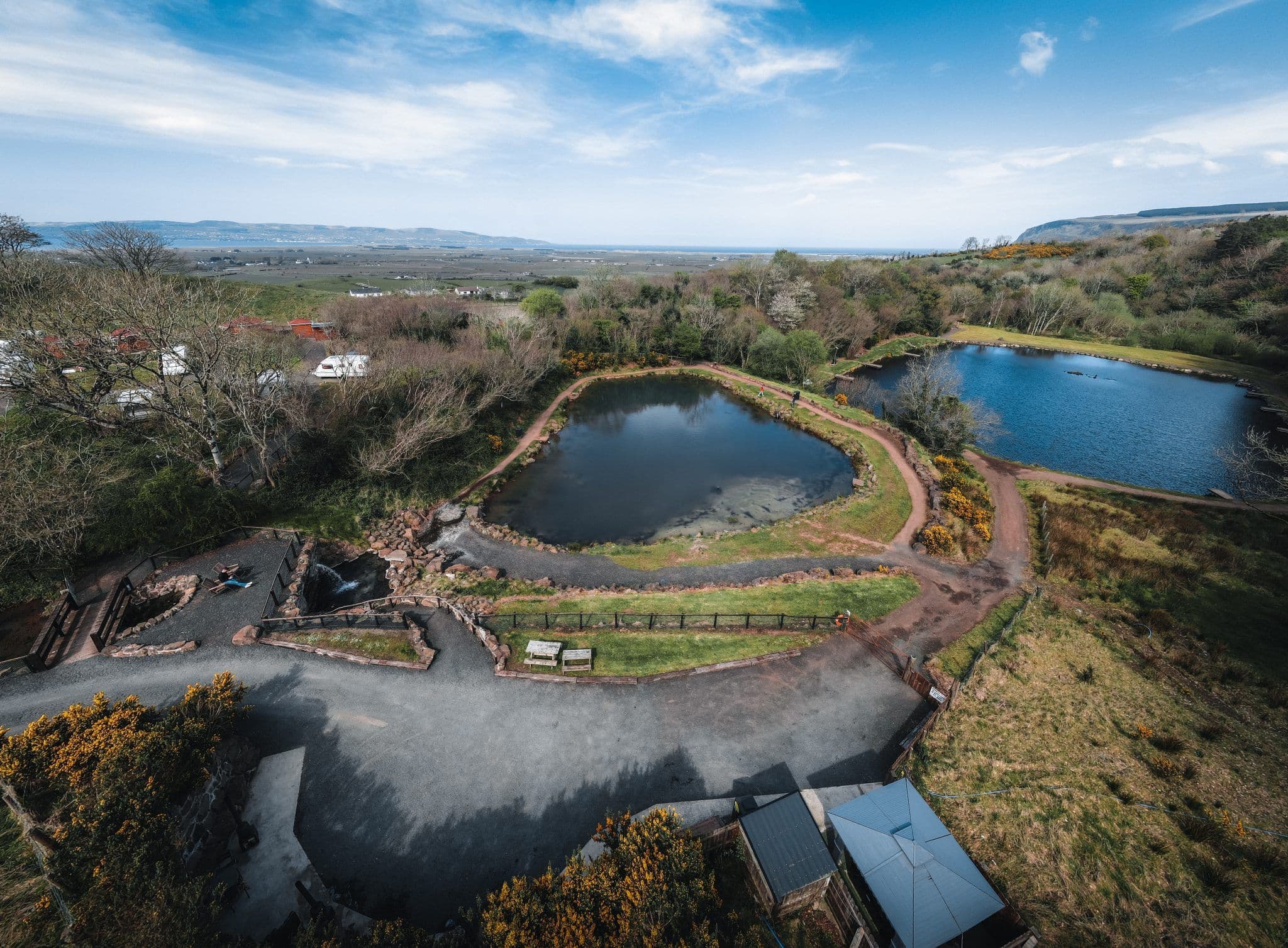 Aerial view of the two spring-fed trout lakes and forest at Tír Hollow Retreat