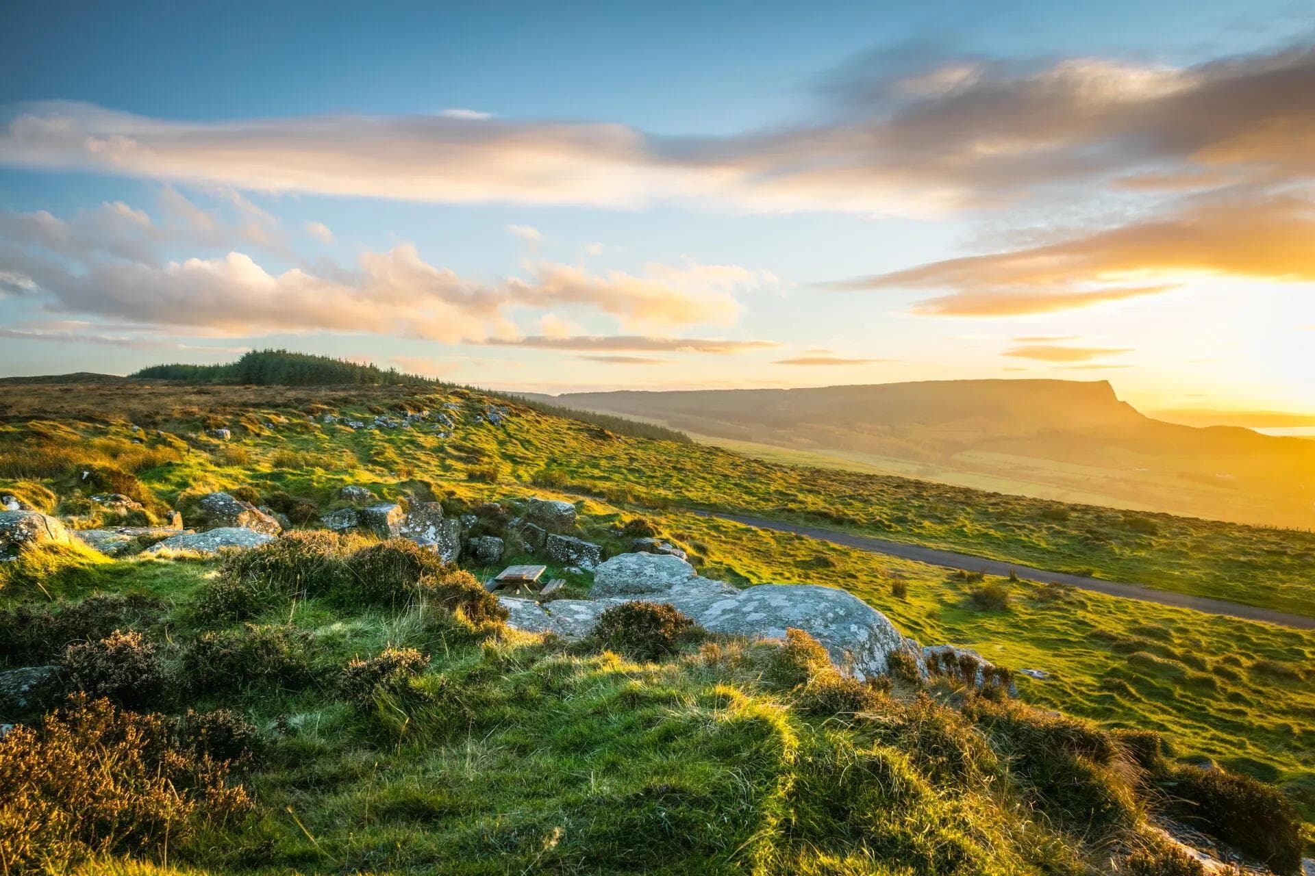 Golden-hour light over the moorland and headland on the Causeway Coast near the retreat
